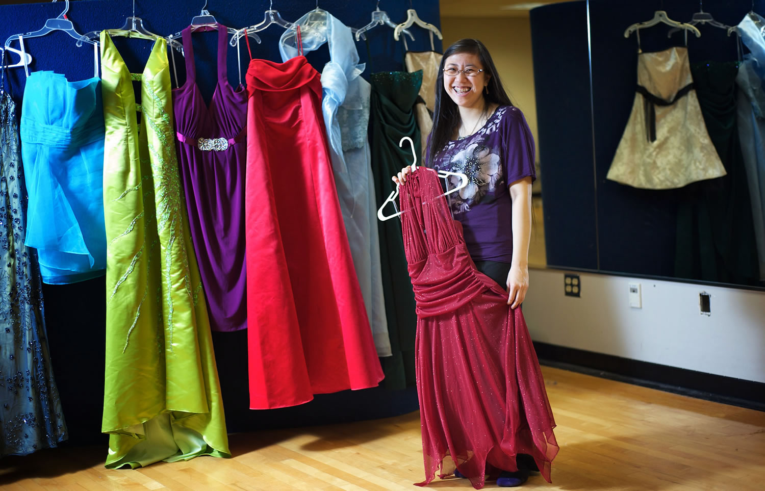 Christina Chen, a senior at Hudson's Bay High School, organizes prom dresses for Saturday's event offering $5 prom dresses to girls attending Vancouver school district high schools.