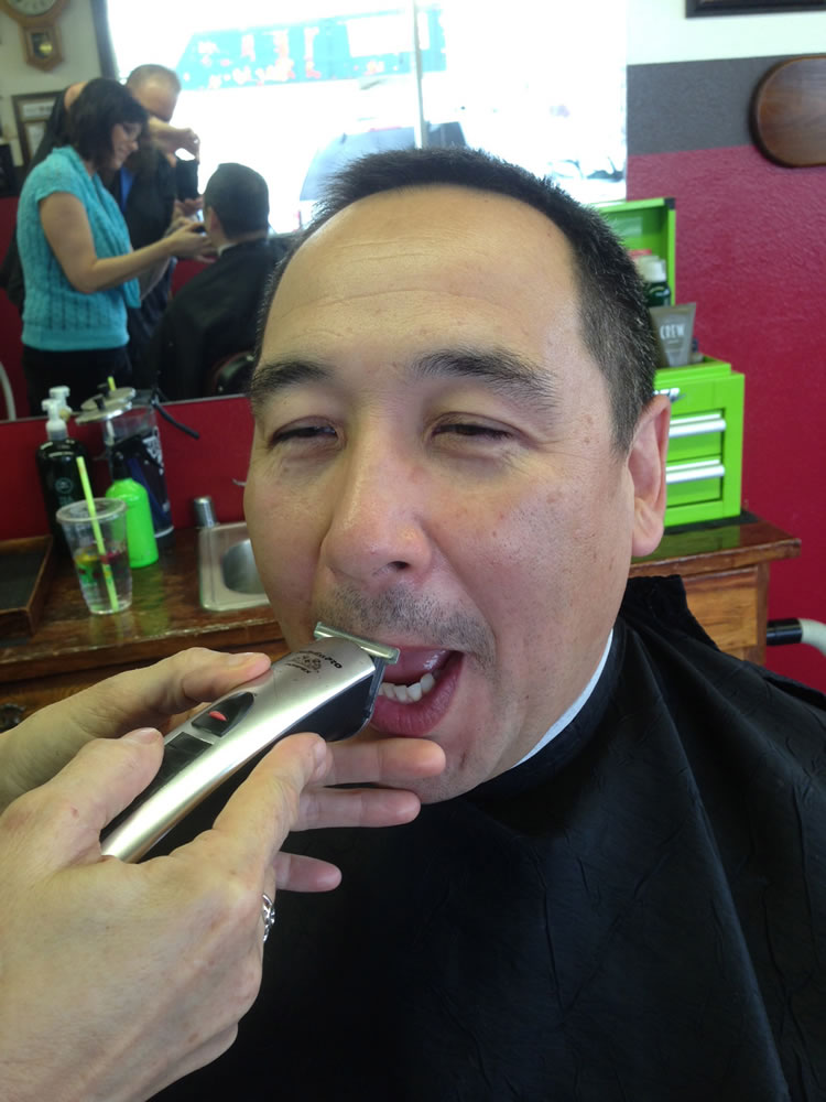 East Precinct: Vancouver Police Officer Cpl. Doug Rickard says goodbye to his mustache as it is shaved off April 2 at Bernie and Rollie's Barber Shop, 10323 S.E. Mill Plain Blvd.