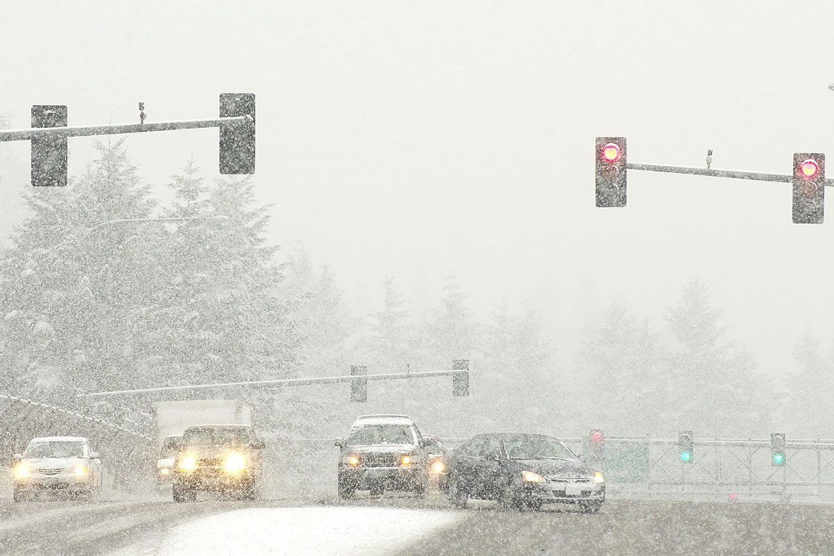Motorists merge onto Interstate 5 south from Northeast 134th Street during heavy snow Feb.