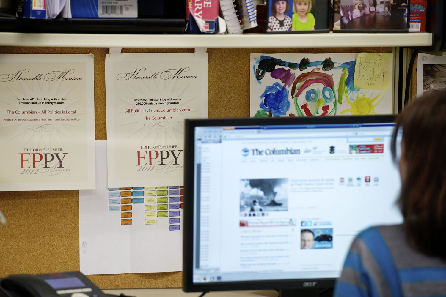 Reporter Stephanie Rice -- part of a team of Columbian bloggers -- displays 2012  EPPY awards for political blogging at her desk.