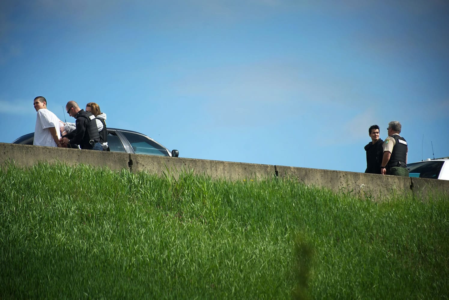 Law enforcement officers take two men in to custody on the southbound shoulder of Interstate 5 just north of the 78th Street exit, after they allegedly robbed the IQ Credit Union on 13505 NE 10th Avenue in Salmon Creek on Thursday.
