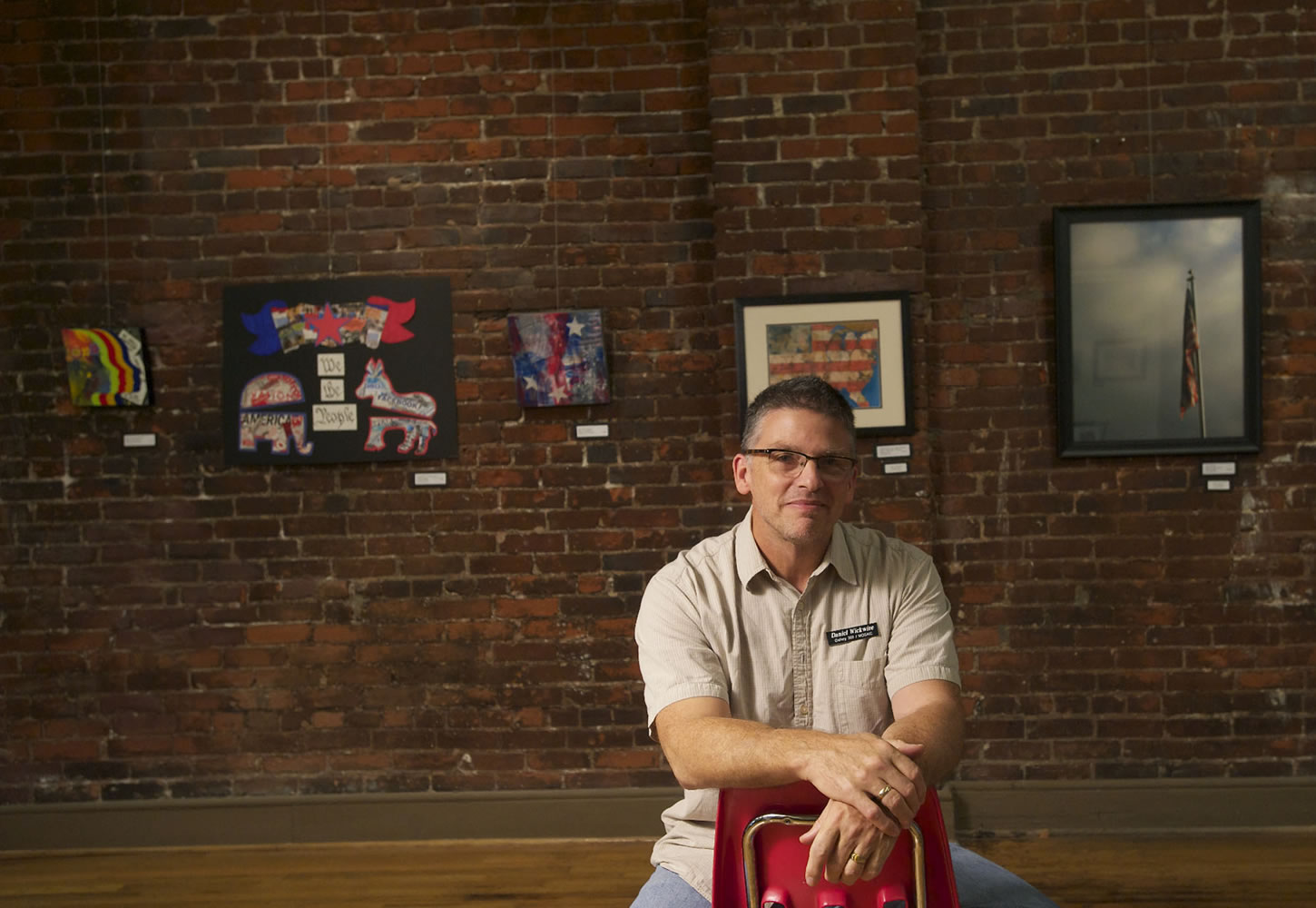 Daniel Wickwire talks about the art exhibit &quot;What is Democracy?&quot; at Gallery 360 on Sunday.