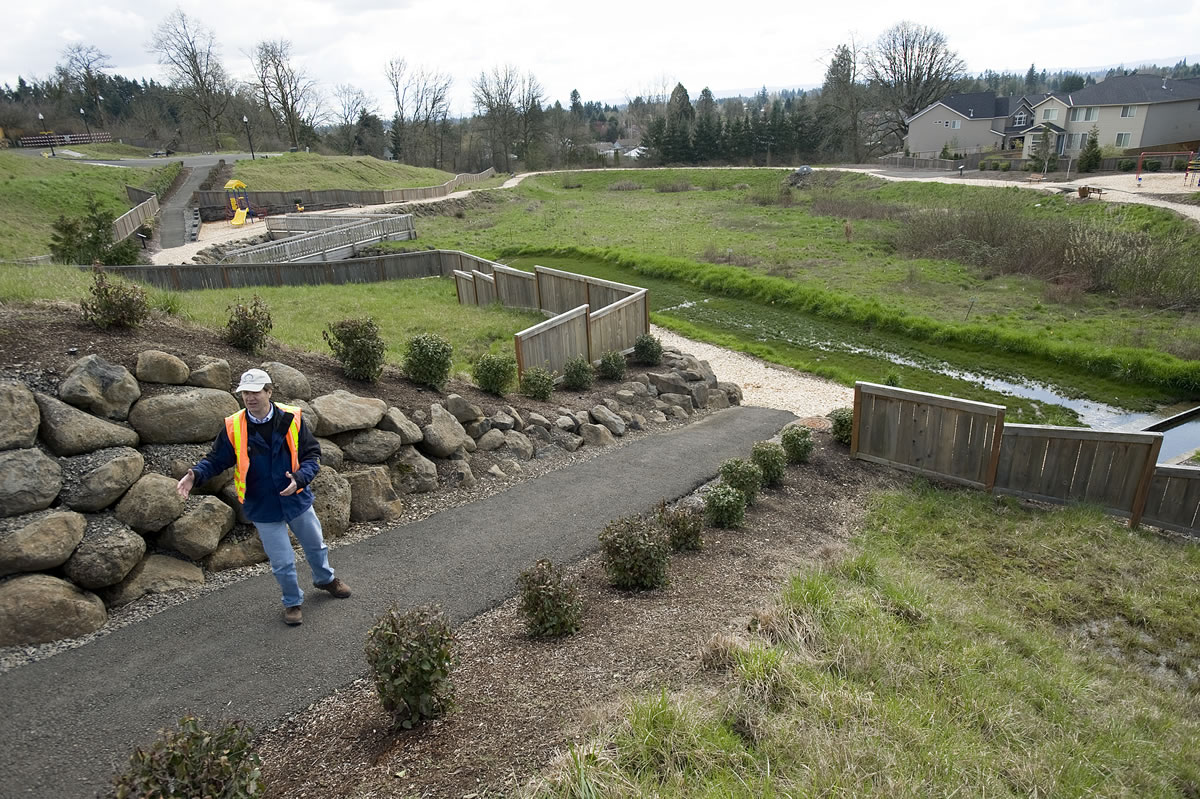 Cary Armstrong, Source Control Specialist with the Clark County Department of Environmental Services, shows a well maintained stormwater site in a Vancouver neighborhood in April 2011. The state's Department of Ecology is committed to working with Clark County on an alternative way for the county to meet clean-water standards, the department's new director, Maia Bellon, told state Rep.