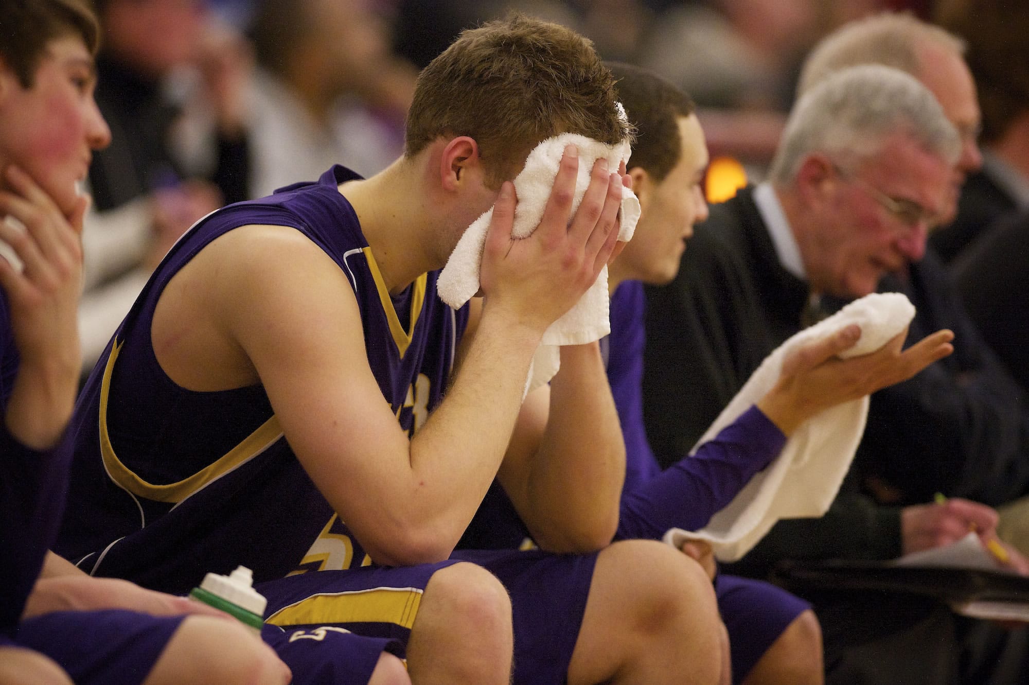 Columbia River's Isaiah Smith buries his head in a towel late in the fourth quarter as Lincoln High School goes on to beat Columbian River 55-35.
