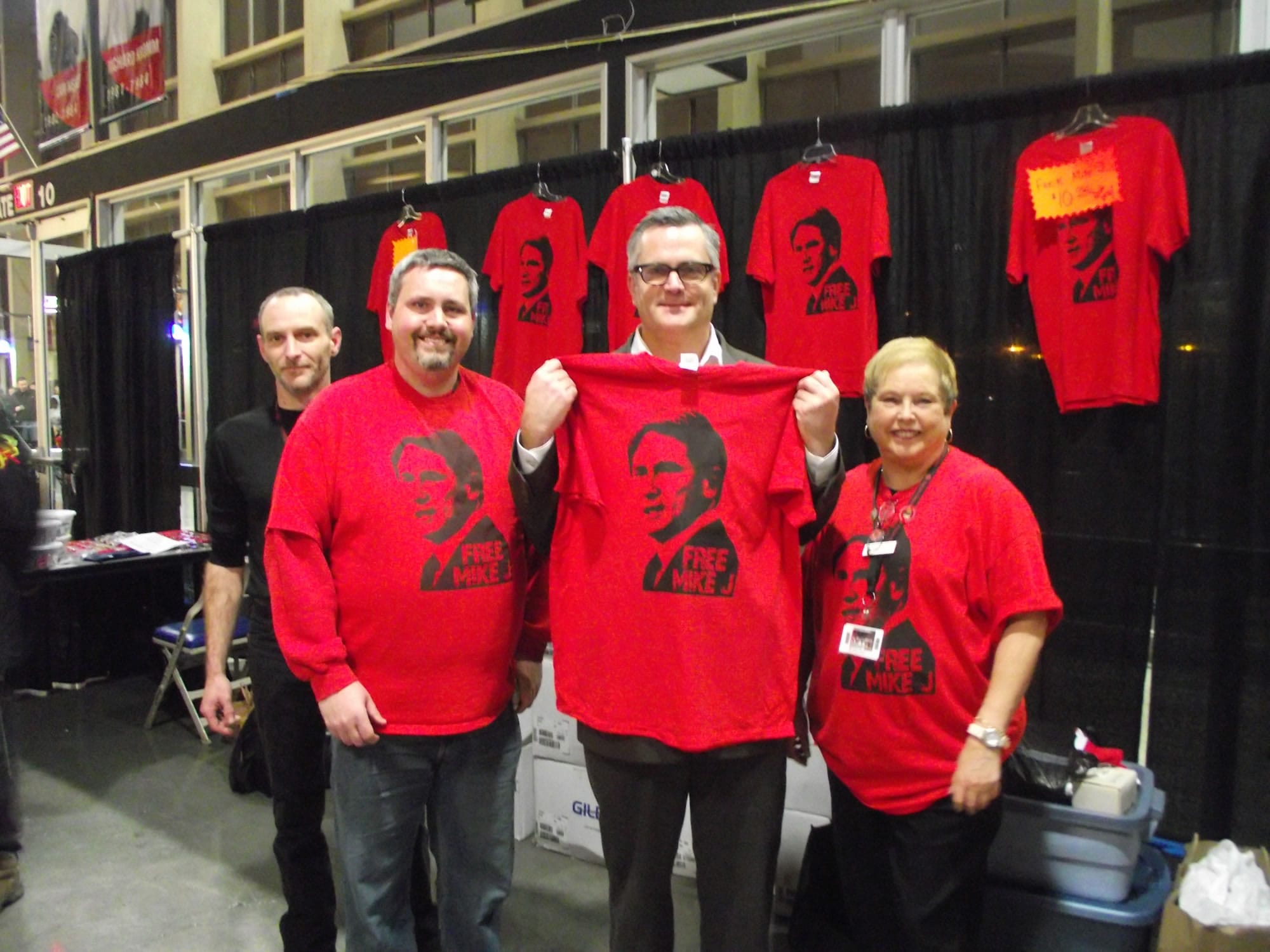 The Portland Winterhawks Booster Club members Pat Thorpe, left, club president Stuart Kemp and treasurer MaryEllen Brown show off a &quot;Free Mike J&quot; T-shirt purchased by Portland Mayor Sam Adams.