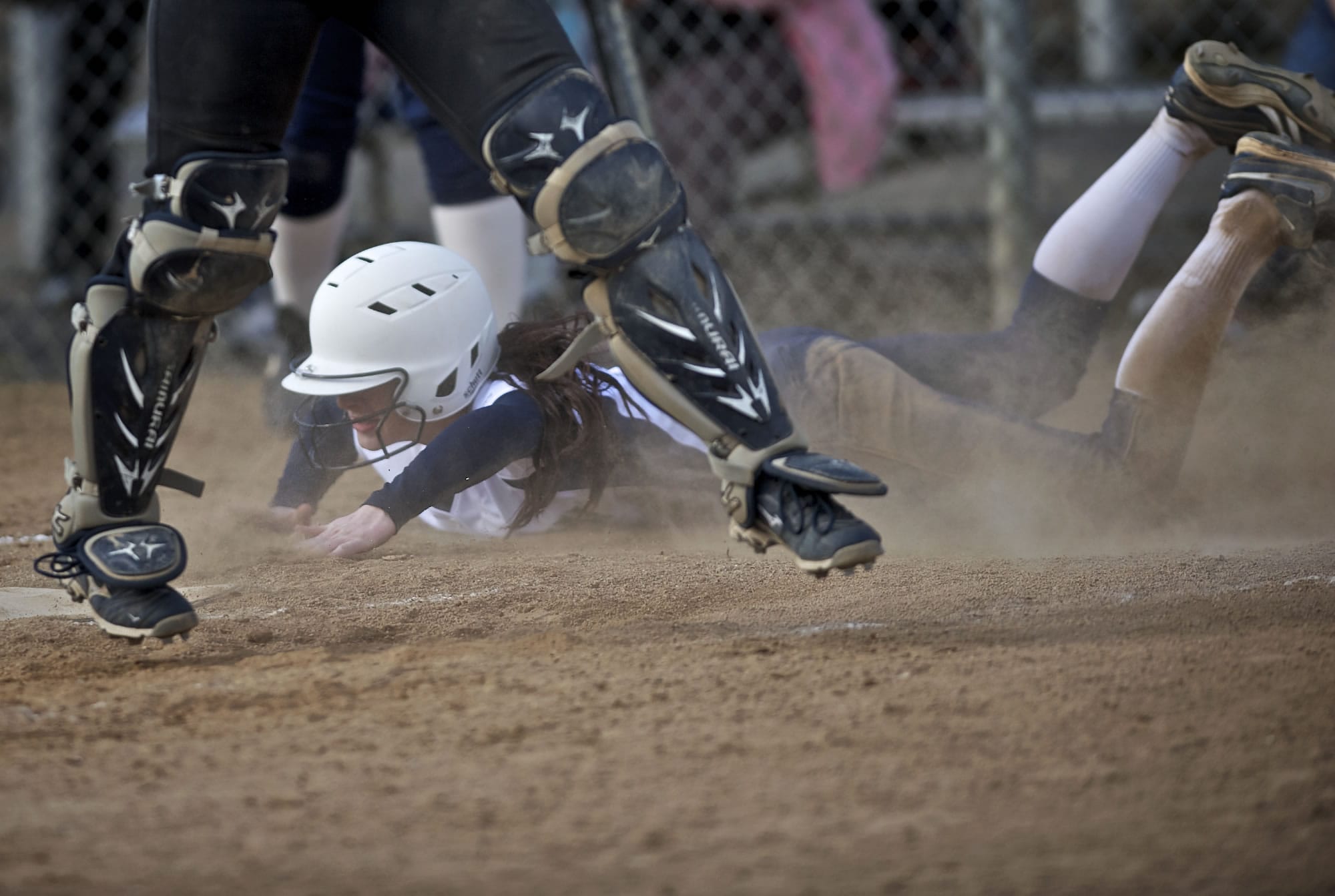 Skyview's Megan Settje slides past home plate after tagging for a run in a non-league softball game against Columbia River.