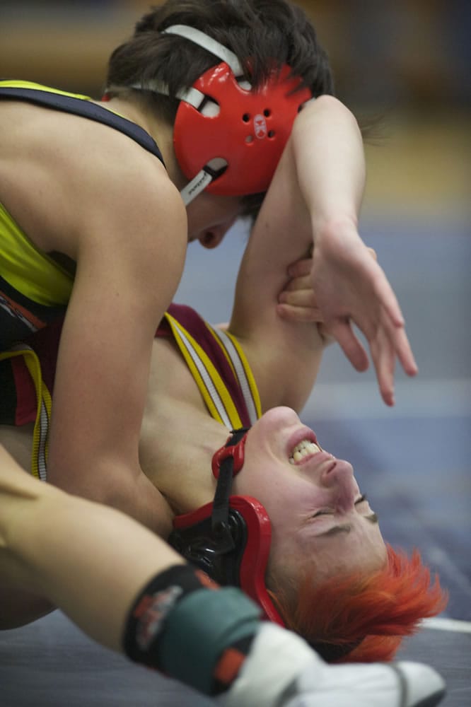 Battle Ground's Kassi Strano,left, takes control of Prairie's Quinn O'Bryant on her way to a win in the 106-pound title.