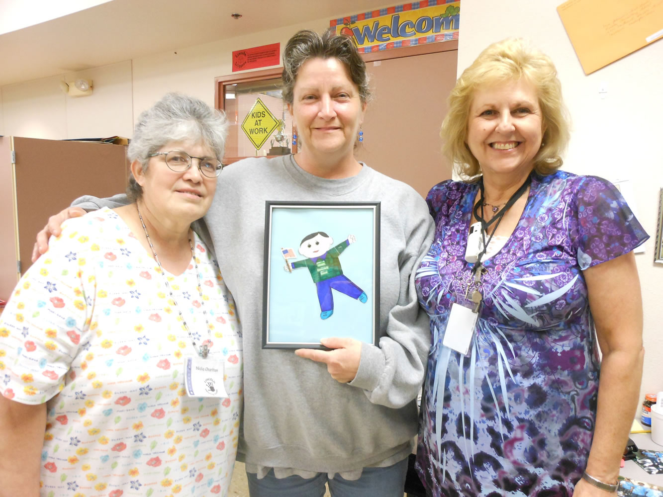 Lincoln: From left, Lincoln Elementary volunteers Nidia Charlton and Colleen Farrell, holding Flat Stanley, pose with first-grade teacher Kathy Johnson.