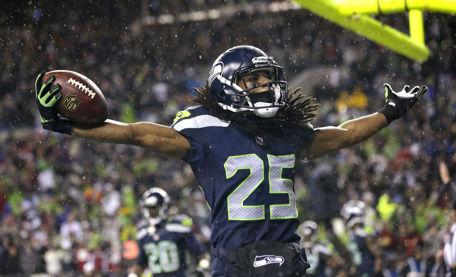 Seattle Seahawks' Richard Sherman motions to fans after an interception in the end zone against the San Francisco 49ers in the second half Sunday.