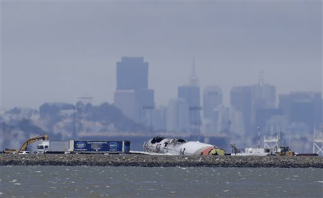 The wreckage of Asiana Flight 214 sits on a tarmac at San Francisco International Airport in San Francisco, Thursday, July 11, 2013. Asiana Airlines Flight 214 from Shanghai and Seoul crash-landed July 6, 2013, when it came in too low and too slow, killing two Chinese passengers and injuring many others as it skidded and spun 100 feet (30 meters).