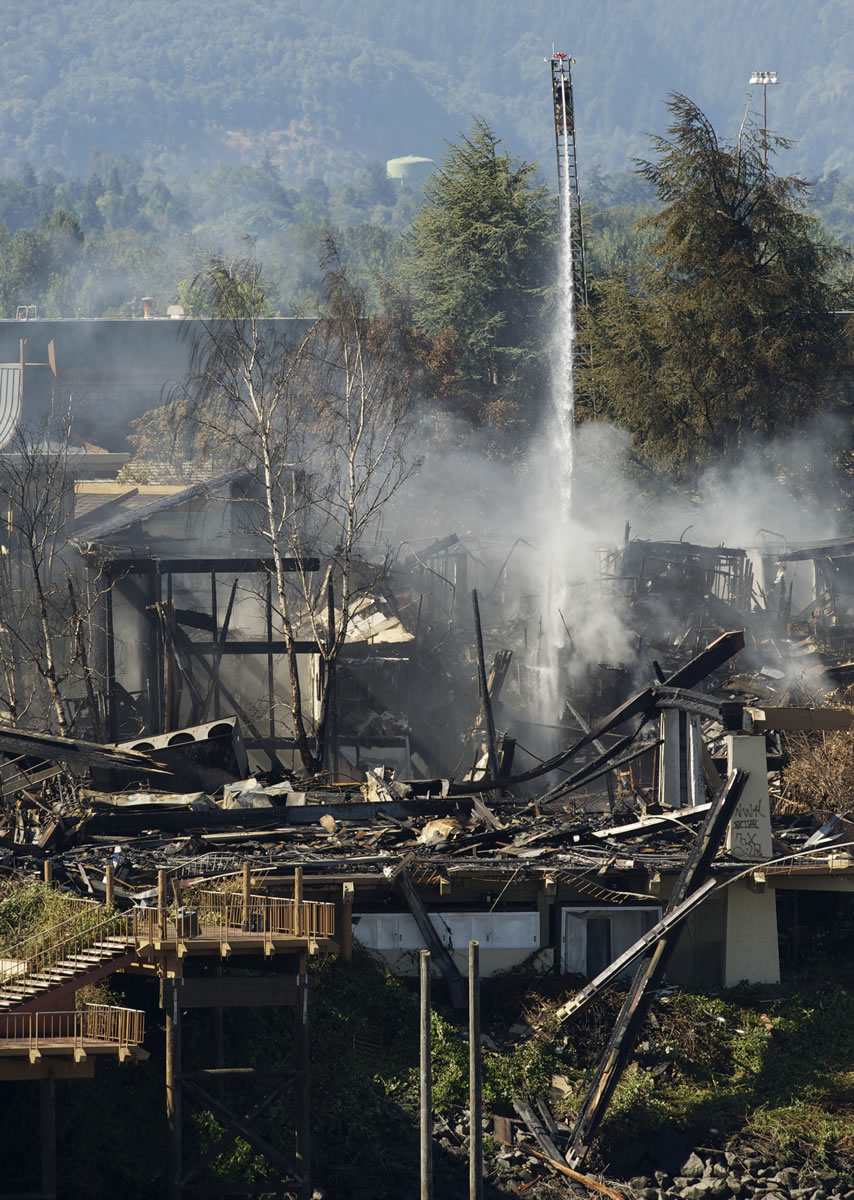 Firefighters on Monday continue to hit hot spots on the ruined Thunderbird hotel on Hayden Island, just across the Columbia River from Vancouver.