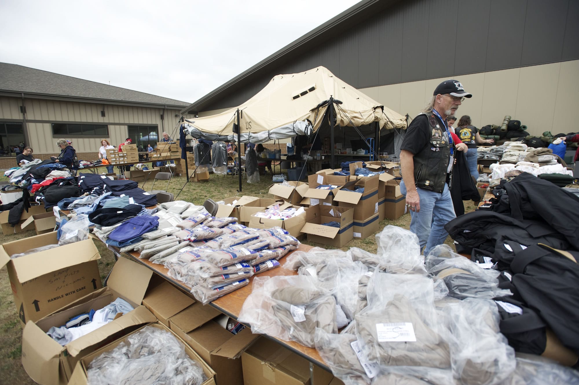 Veteran Cliff Nutting hands out clothing at the annual veterans stand-down event at the Armed forces Reserve Center in 2012.