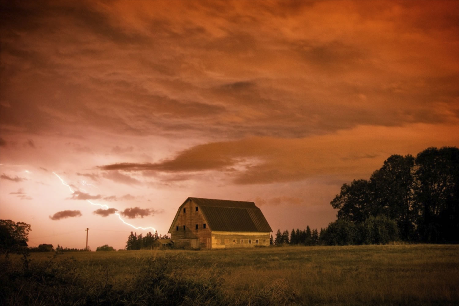 A lightning bolt lights up the sky over an old barn in Ridgefield early this morning. A total of 19 lightning strikes reached the ground in Clark County, according to the National Weather Service in Portland. The photo was shot at 2 a.m.