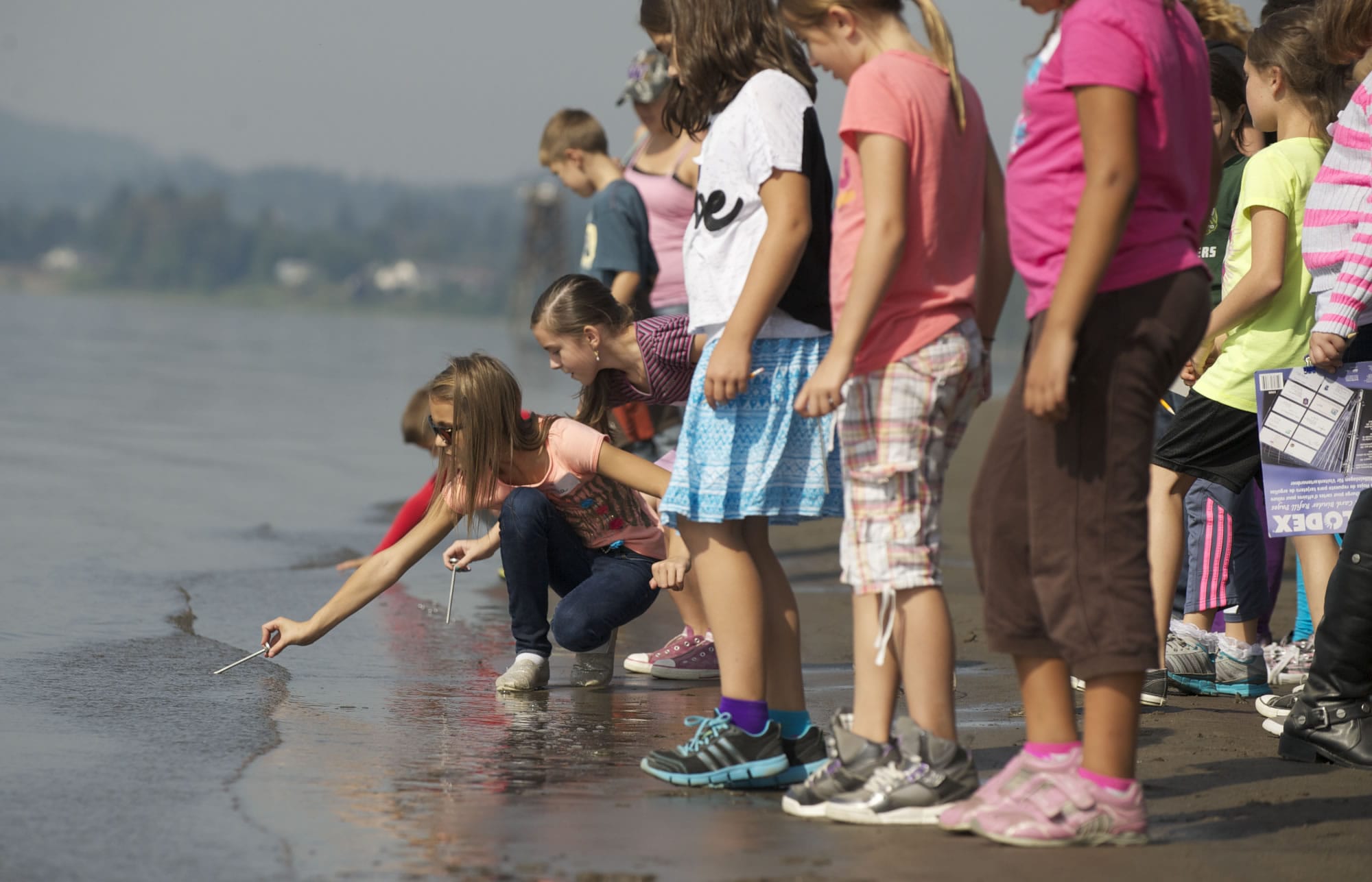 Fourth-graders from Grass Valley Elementary check the water temperature of the Columbia River at Captain William Clark Park Friday.
