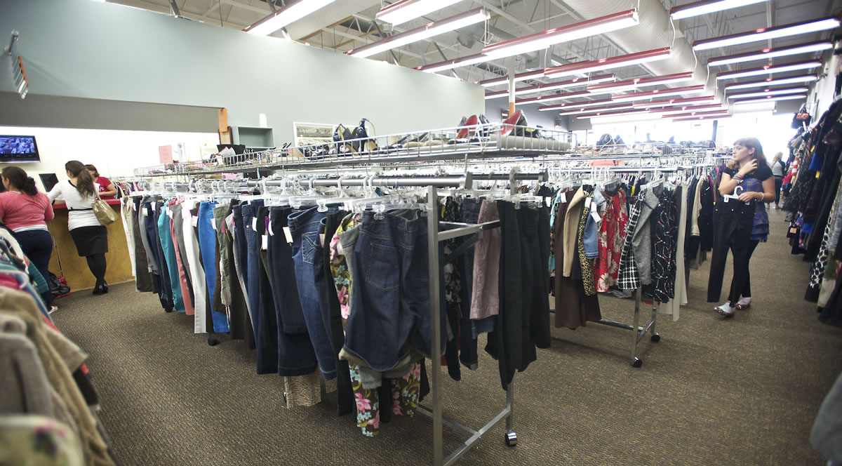 Shoppers look through the aisles and sellers visit the desk at Spanky's consignment shop on Wednesday.