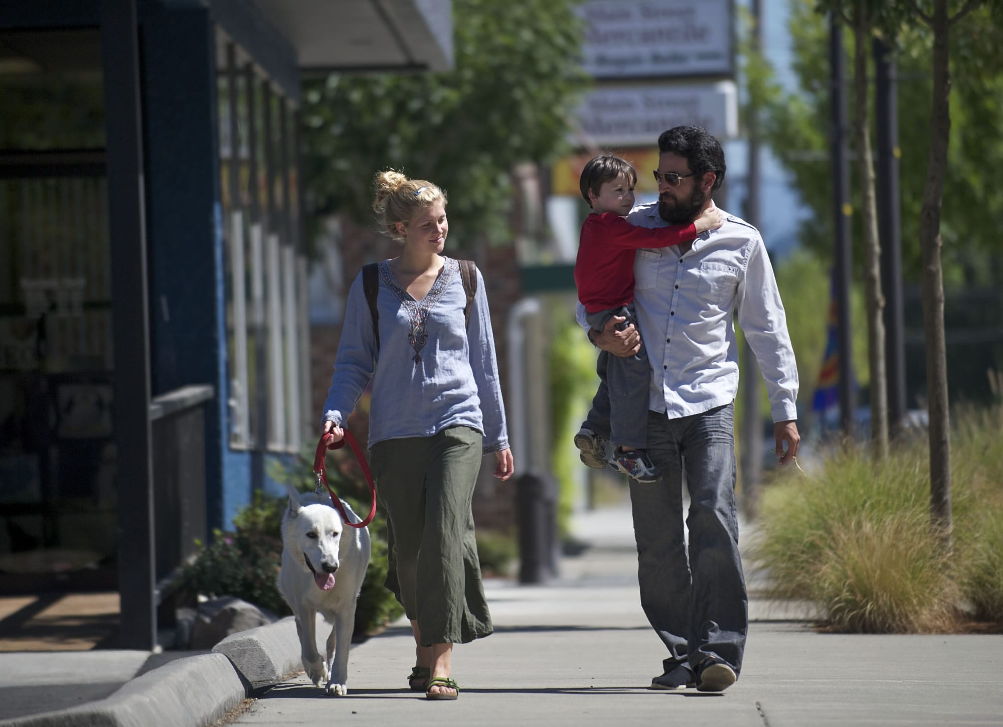 Grace Edwards, left, walks down Main Street in Washougal with her mother's boyfriend Joel Gibby, her nephew Efram August, 4, and her dog Rex last week.