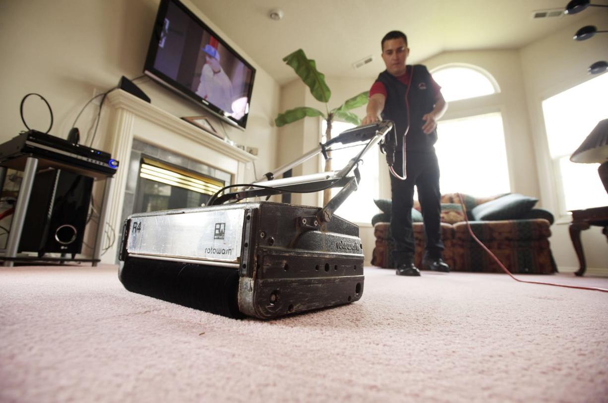 Photos by Steven Lane/The Columbian
Quam's Carpet Cleaning employee Shane Morgan cleans a carpet July 17 at the home of a family friend.