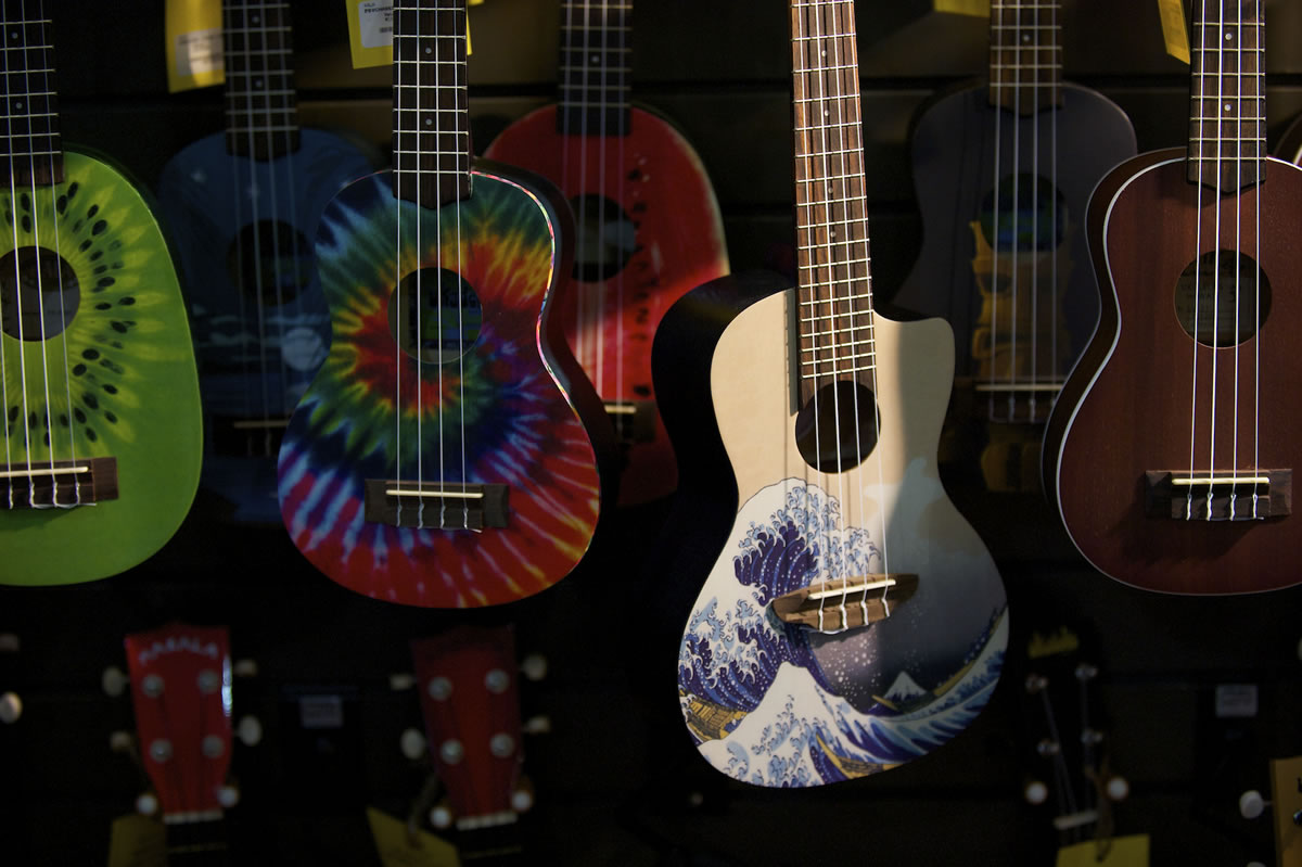 An array of ukuleles hangs on the wall at Beacock Music.