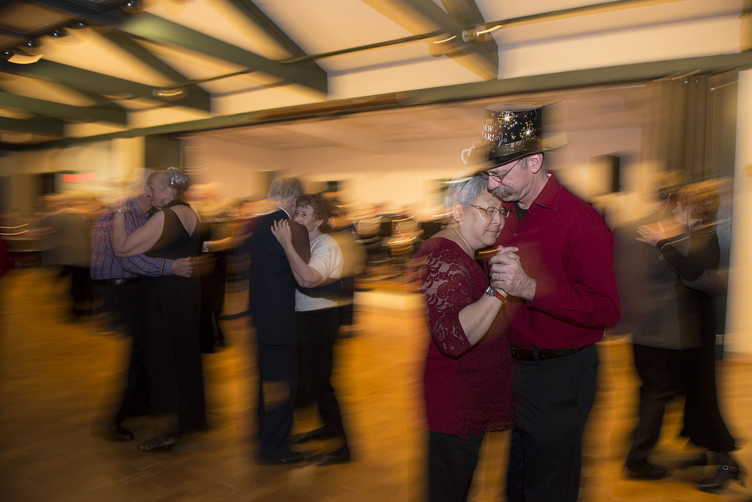 Marita and Rick Bay of Battle Ground, couple in foreground, celebrate New Year&#039;s Eve by dancing cheek to cheek during a slow song Thursday night at the Luepke Senior Center.