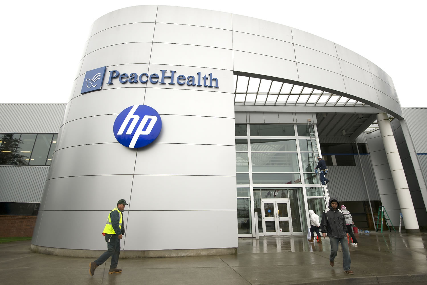 People walk in March outside Hewlett-Packard's offices at Columbia Center at Columbia Tech Center in east Vancouver.