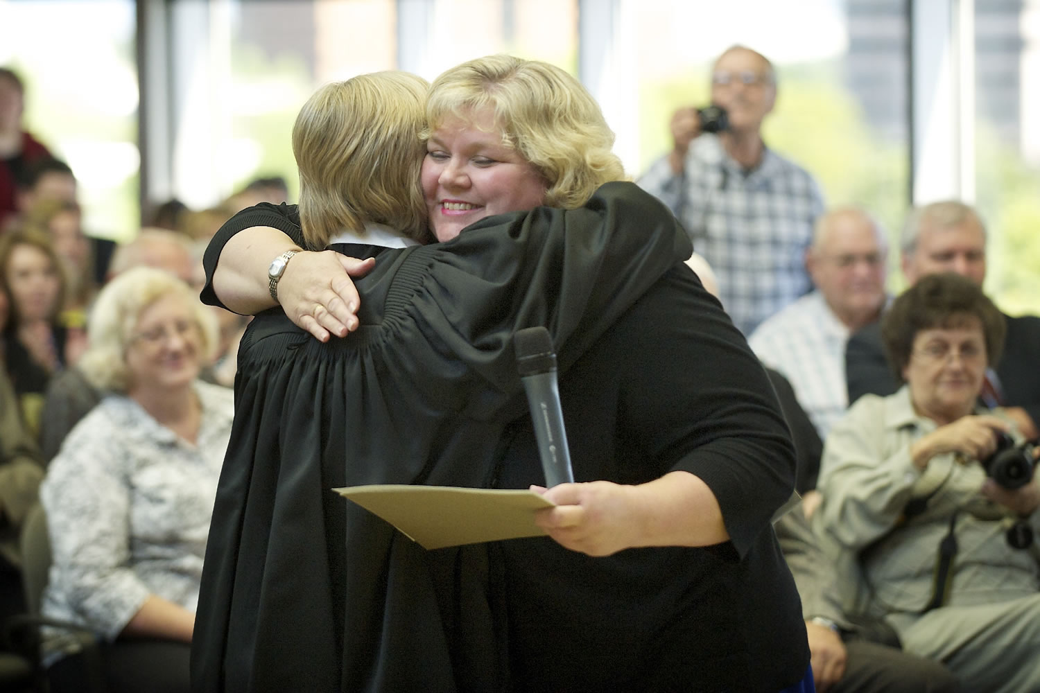 Suzan Clark, right, is embraced by Clark County Superior Court Judge Barbara Johnson after being sworn in as the county's newest Superior Court judge Friday at the Clark County Public Service Center.