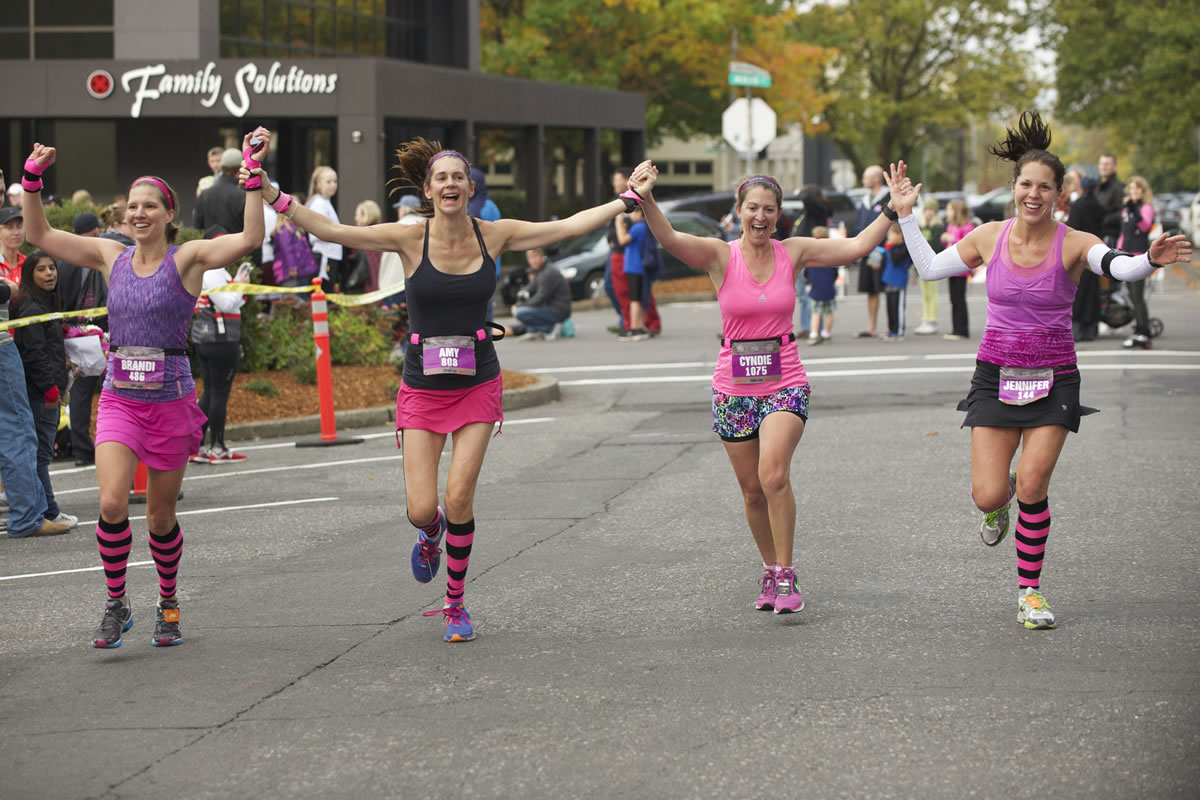 A quartet of happy runners approaches the finish line Sunday morning in the seventh Girlfriends Half Marathon in downtown Vancouver. An estimated 1,800 women competed in the 13.1-mile race that benefitted Susan G.