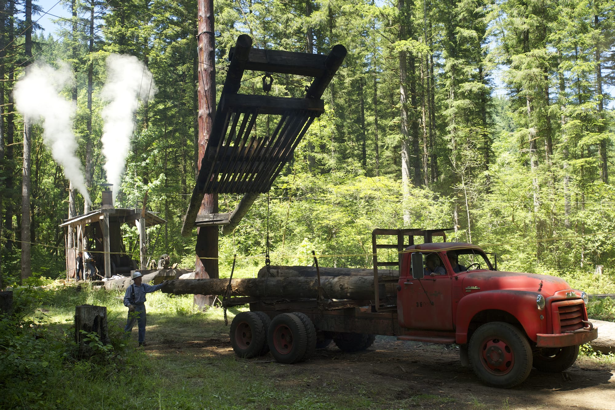 A yarder donkey moves logs into position as the heel boom loader places the trees onto a waiting truck during the Pomeroy Living History Farm's steam logging demonstration on Sunday.