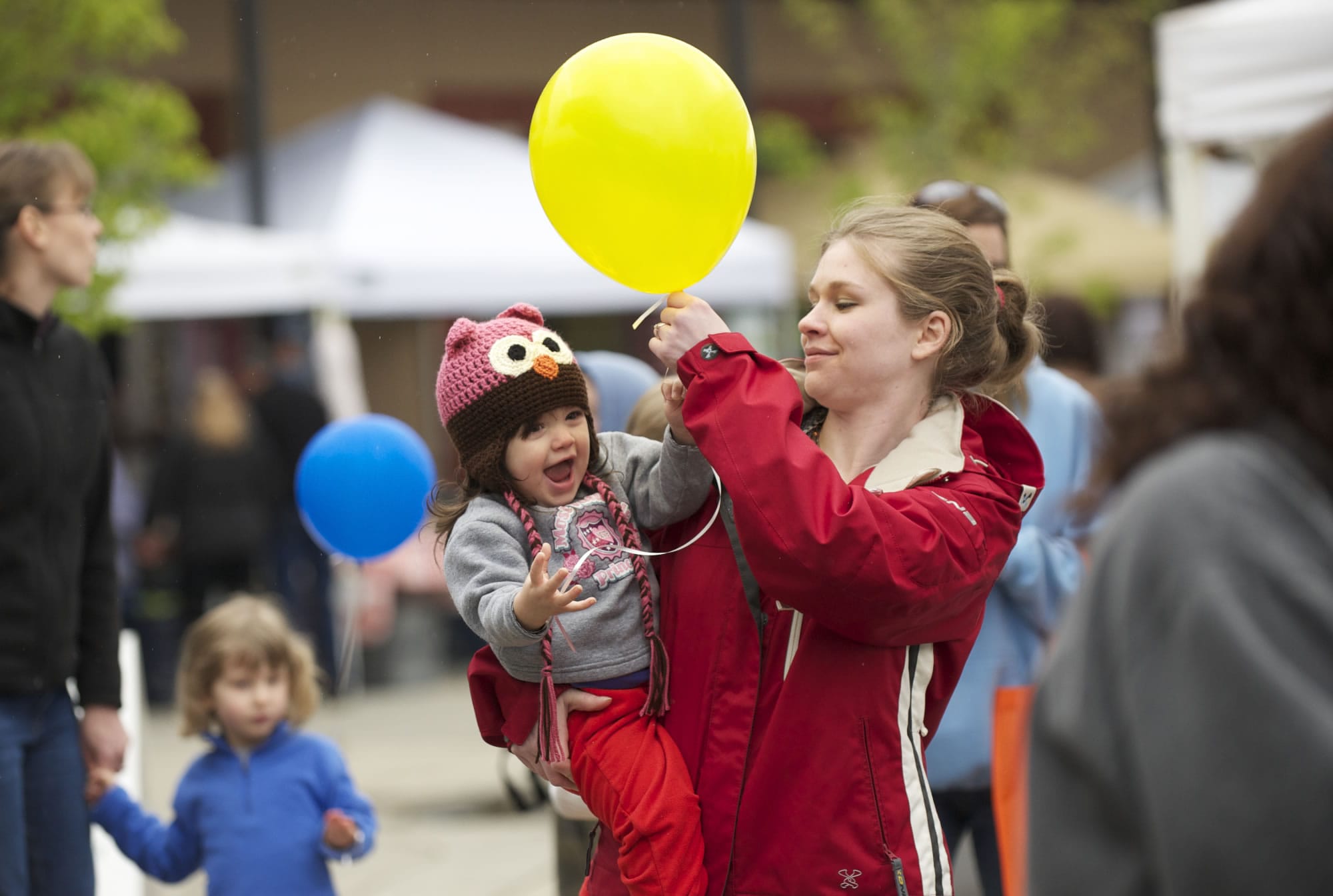 Jennifer Solverson and her 18-month-old daughter, Bethany Nease, enjoy  the Battle Ground Village Outdoor Market as it kicks off its spring season.