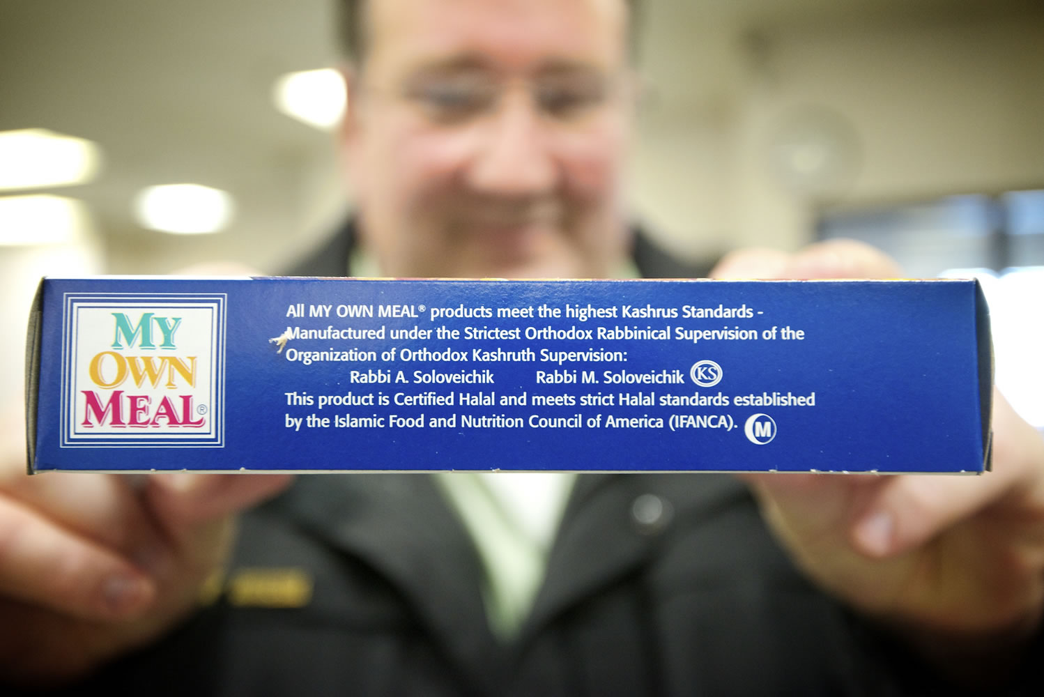 Joe Loftgren, food services manager at the Clark County Jail Work Center, holds a kosher dinner meal box detailing the kosher certification of a prepackaged meal.