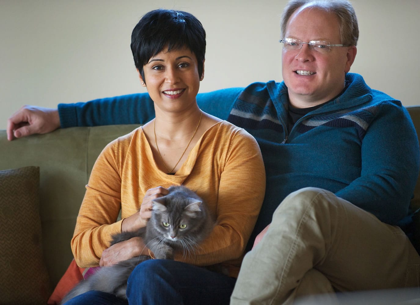 David Gregerson and his wife, Maya Bhat-Gregerson, with their cat, Lola.