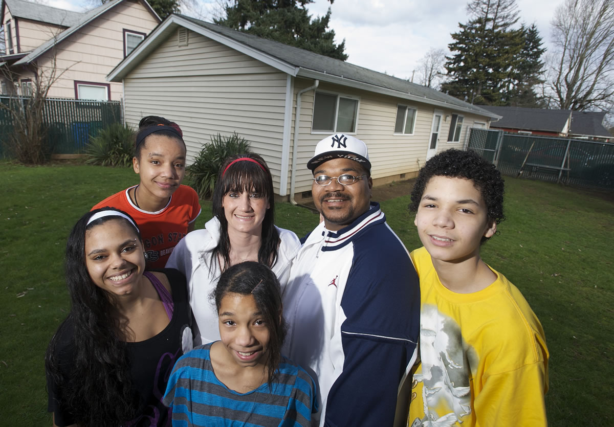 Terry and Dusty Barrow and their children, from left, Lynnese, 15, Aadina, 17, Shamar, 11, and Terry Jr., 14, say the lessons they've learned from personal finance classes helped them save money that they hope will allow them to buy the house they've long rented.