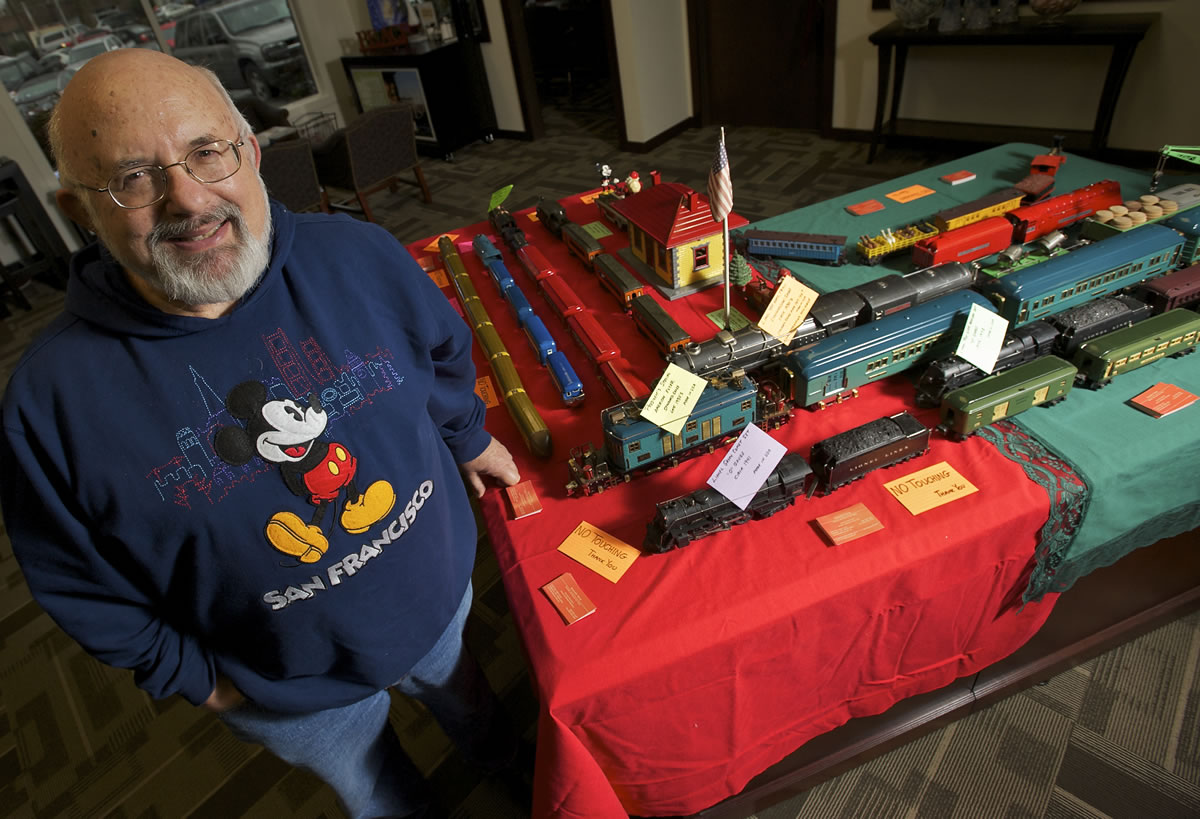 David Dansky, 75, poses by a display of toy trains from his collection, which he lent to the downtown Vancouver Umpqua Bank for December.