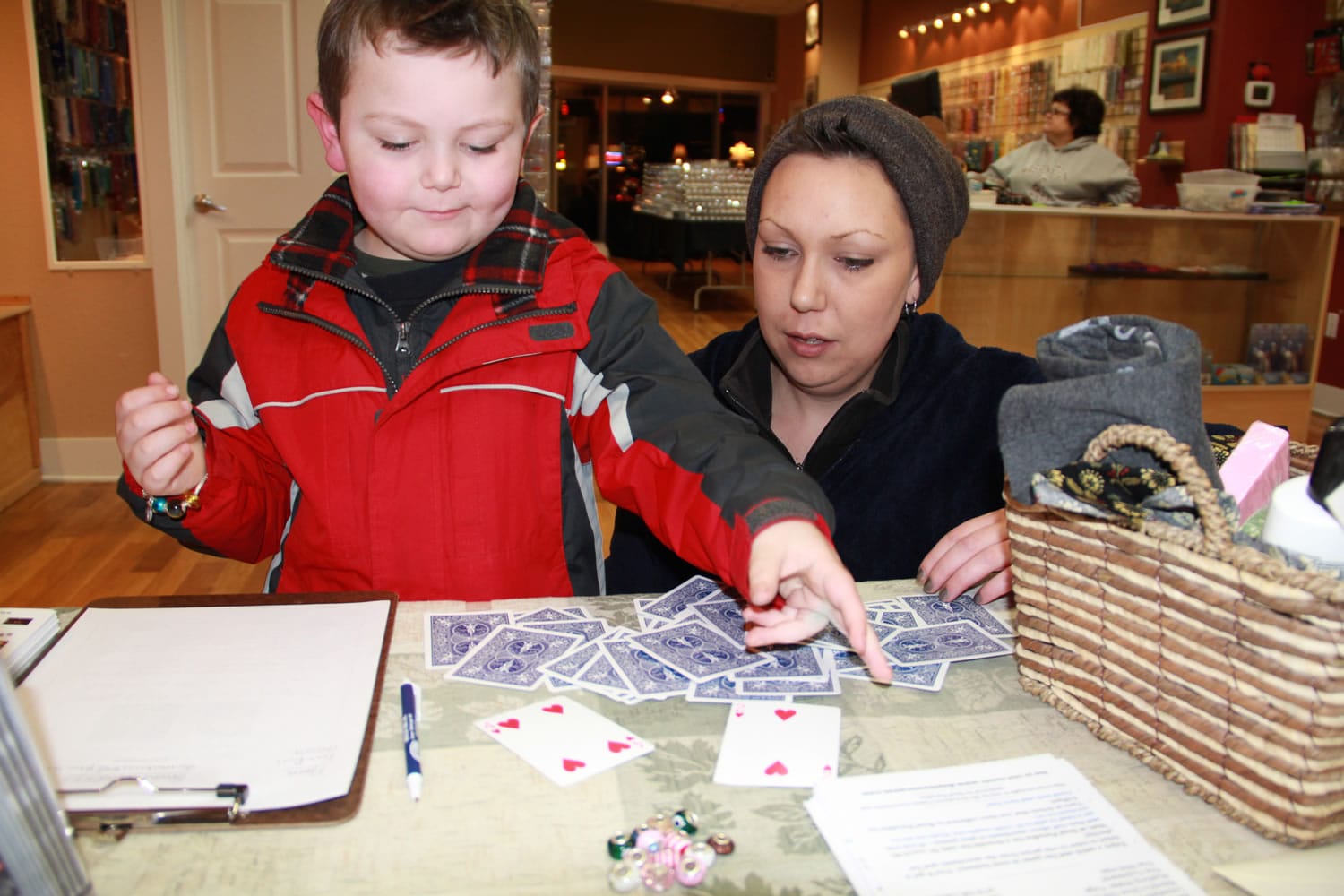 Camas: A young boy plays a card game at Bead Paradise, part of the Downtown Camas Association's First Friday event Jan.