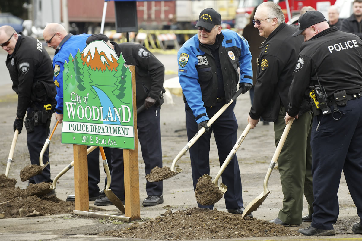 Woodland Police Chief Rob Stephenson, third from right, with other officers, breaks ground for a $2 million police station.
