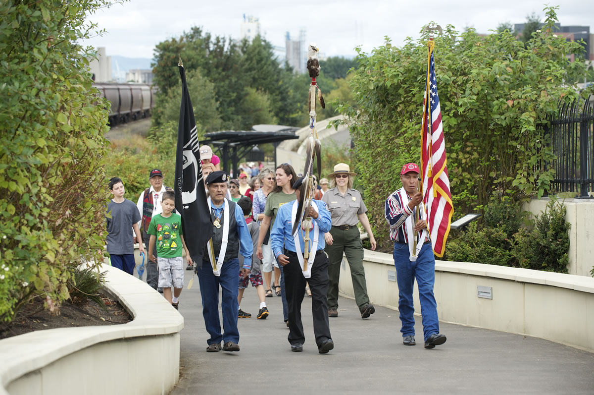 The Northwest Indian Veterans Association Color Guard leads a procession Saturday over the 5-year-old Vancouver Land Bridge to the village at the Fort Vancouver National Historic Site.