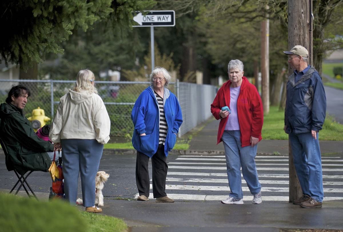 Neighborhood Traffic Safety Alliance Chair Ross Montgomery, right, discusses pedestrian safety issues on April 8 at the corner of East 29th and R Streets with Rose Village neighborhood residents Frank Choate, from left, Donna Dummann, Arlene Forbes and Sue Nagy.