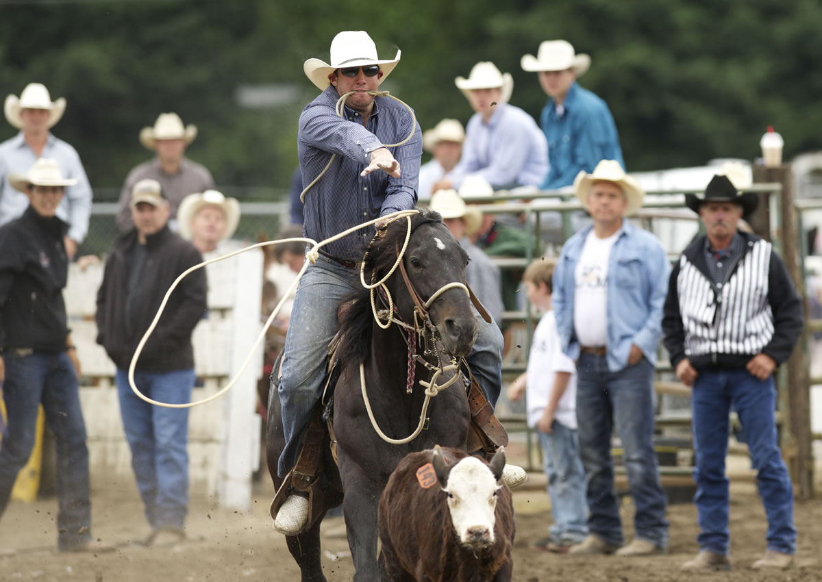 Photos by Steven Lane/The Columbian
Chase Richter of Weatherford, Texas, on his quarter horse Pay Day, competes in the tie-down roping event during the Vancouver Rodeo's Saturday morning session. He'd already competed in five Oregon rodeos through the July 4 week, and was planning another Saturday night.