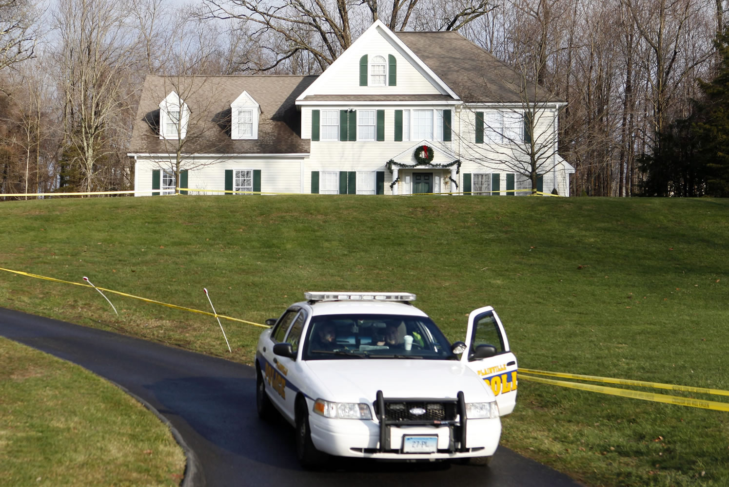 A police cruiser sits in the driveway as crime scene tape surrounds the home of Nancy Lanza on Dec. 18 in Newtown, Conn. Nancy Lanza was killed Dec.