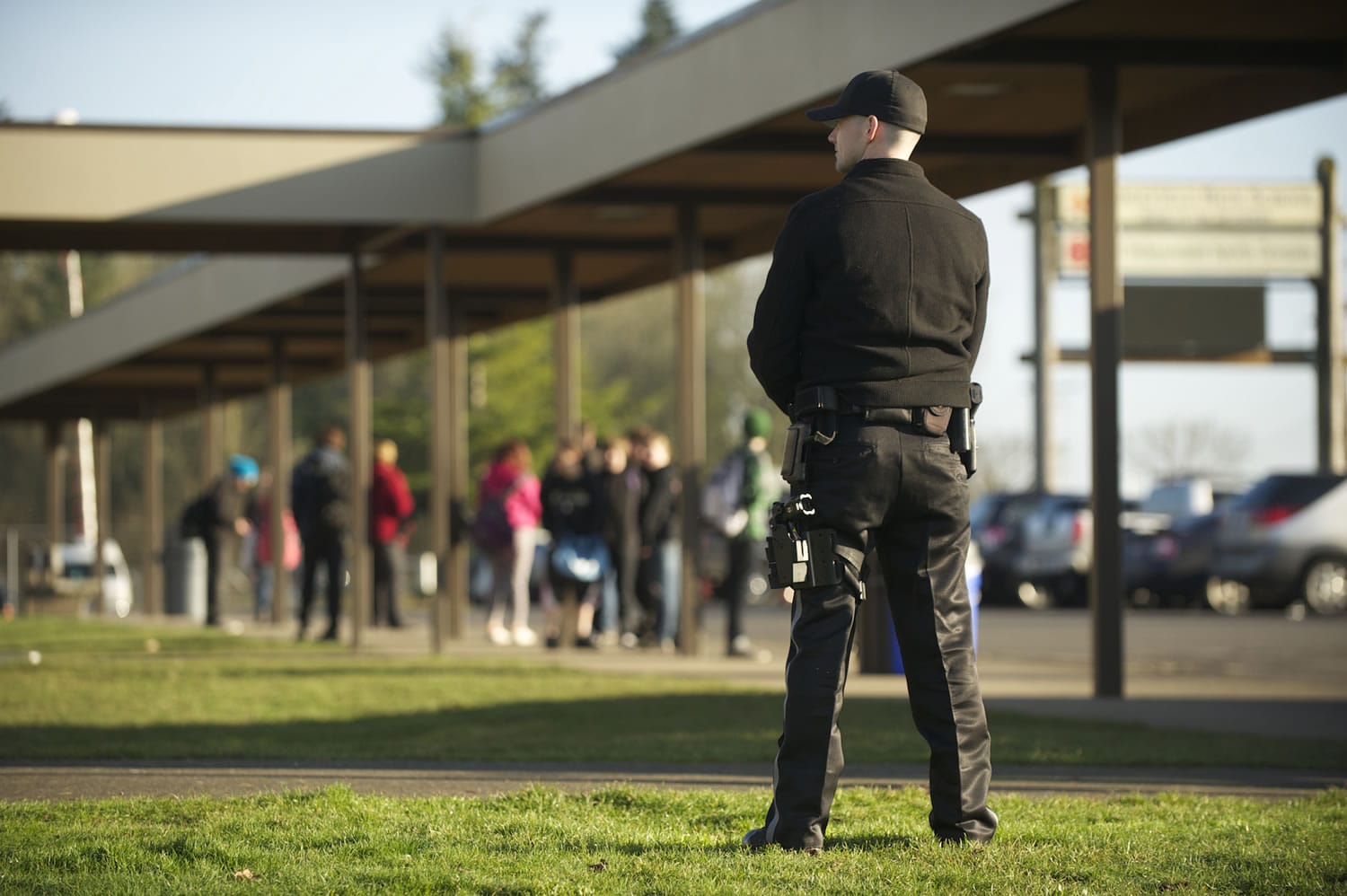 Armed security guard James Mortenson, from Phoenix Protective Corporation, patrols Ridgefield High School as students are released for the day on  Jan. 17.