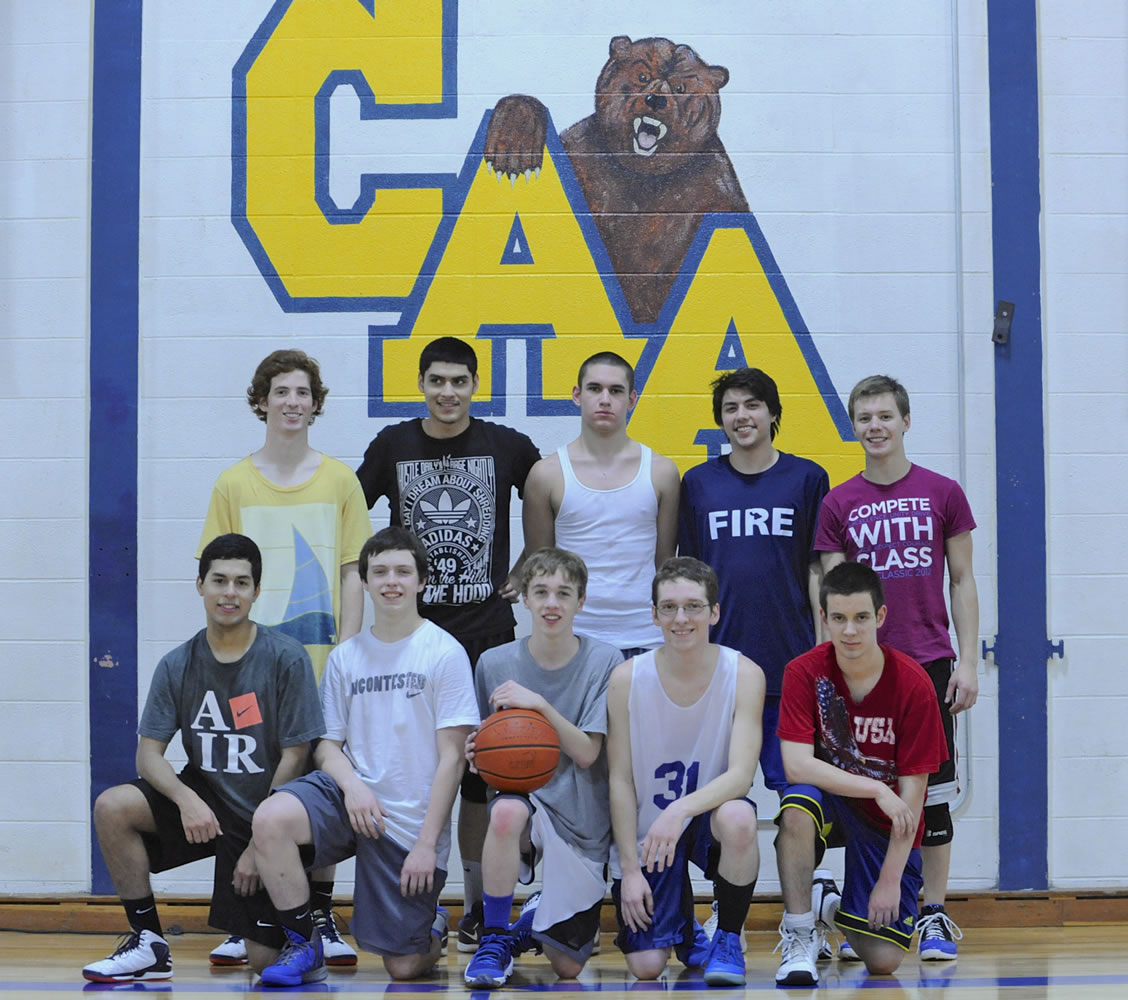 Members of the Columbia Adventist Boys Basketball team pose in their Battle Ground gym.