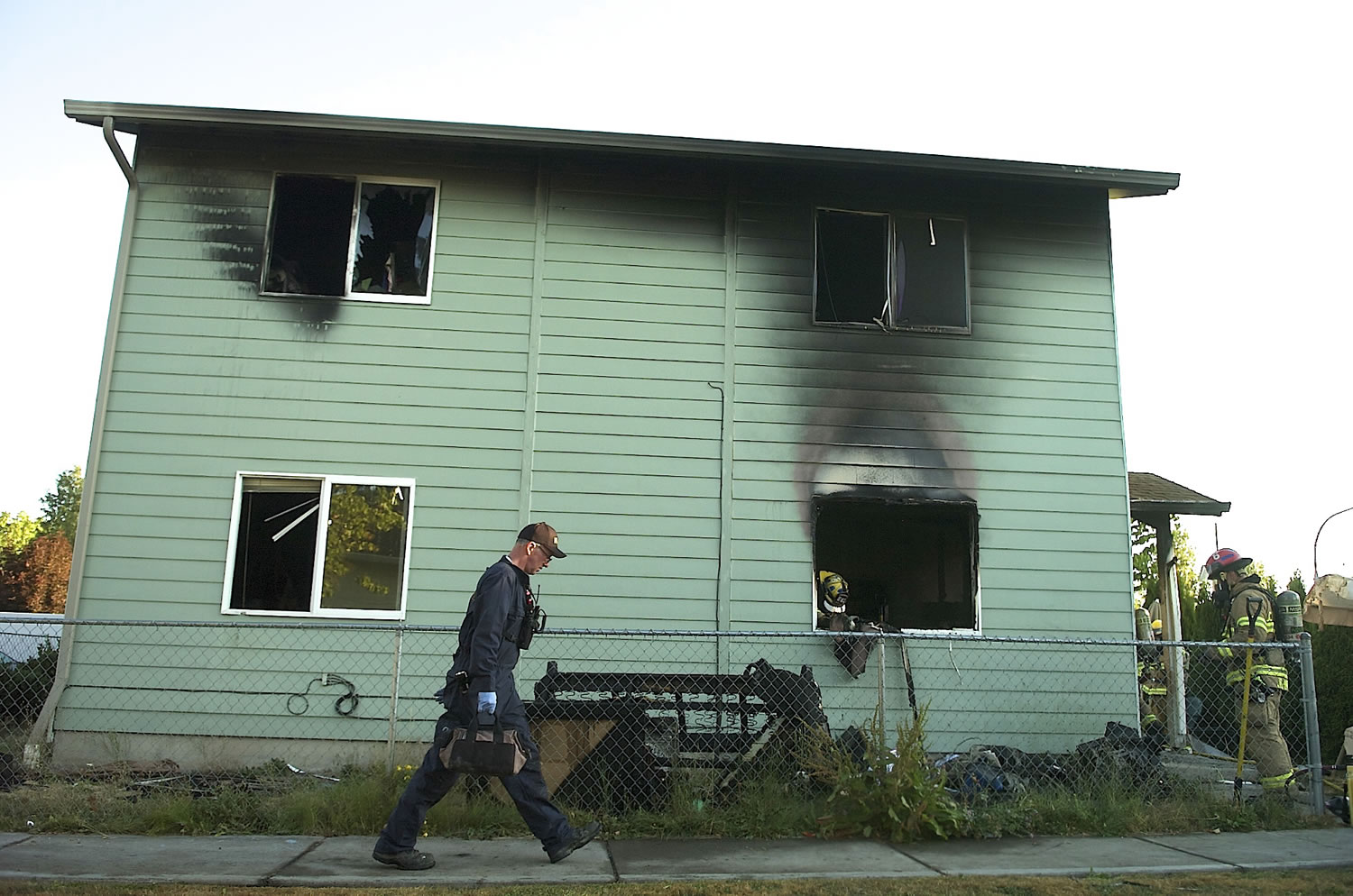 Clark County Deputy Fire Marshal Ken Hill responds to a Salmon Creek house Tuesday morning after a fire caused significant damage to the structure.