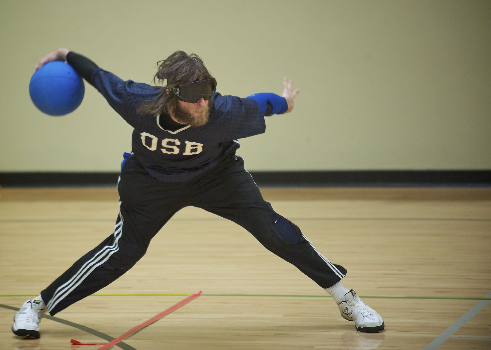 John Hinman, 26, takes a shot as athletes practice for the 2013 National Goalball Championship at the Washington State School for the Blind on Monday.