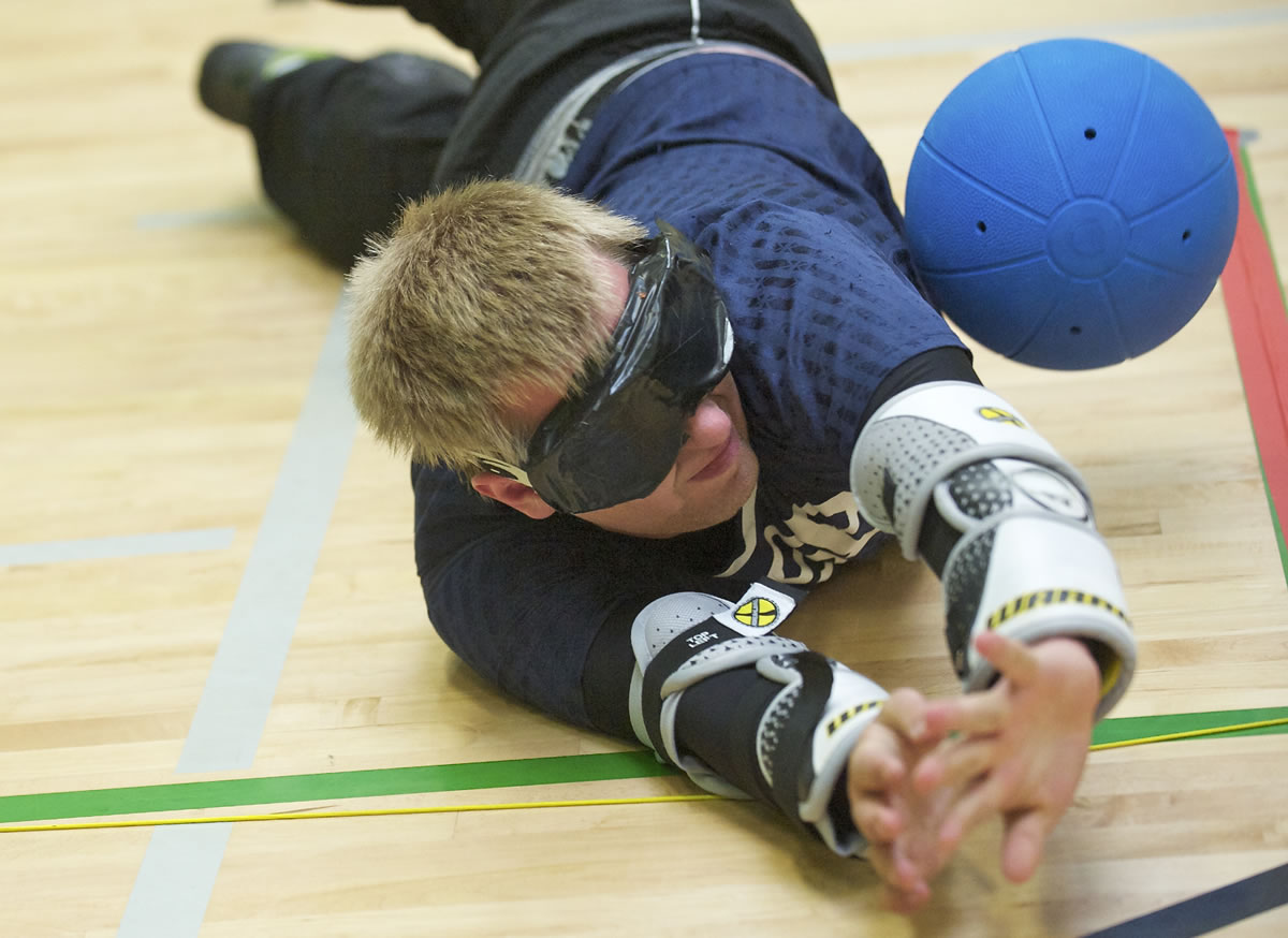 Dalton Williams, 21, blocks a shot as athletes practice for the 2013 National Goalball Championship at the Washington State School for the Blind on Monday J.