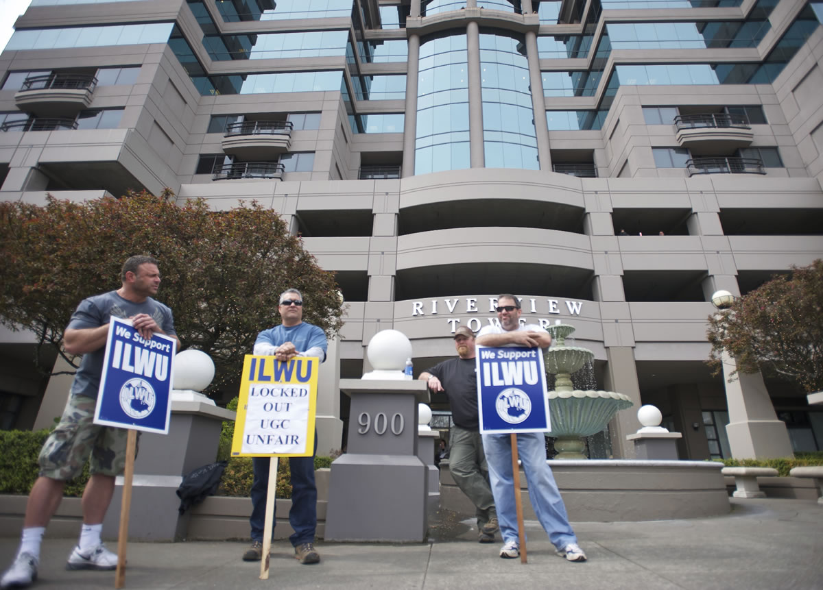A small group of picketers stand outside the Riverview Bank building, where United Grain has an office, on April 3 as the lockout continues at the United Grain terminal at the Port of Vancouver.