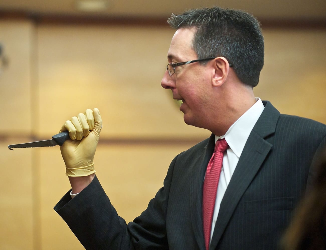During closing arguments Wednesday, Clark County Prosecuting Attorney Tony Golik shows the jury a bent knife, one of five Dennis Wolter allegedly used to kill his estranged girlfriend, Kori Fredericksen, in May 2011.