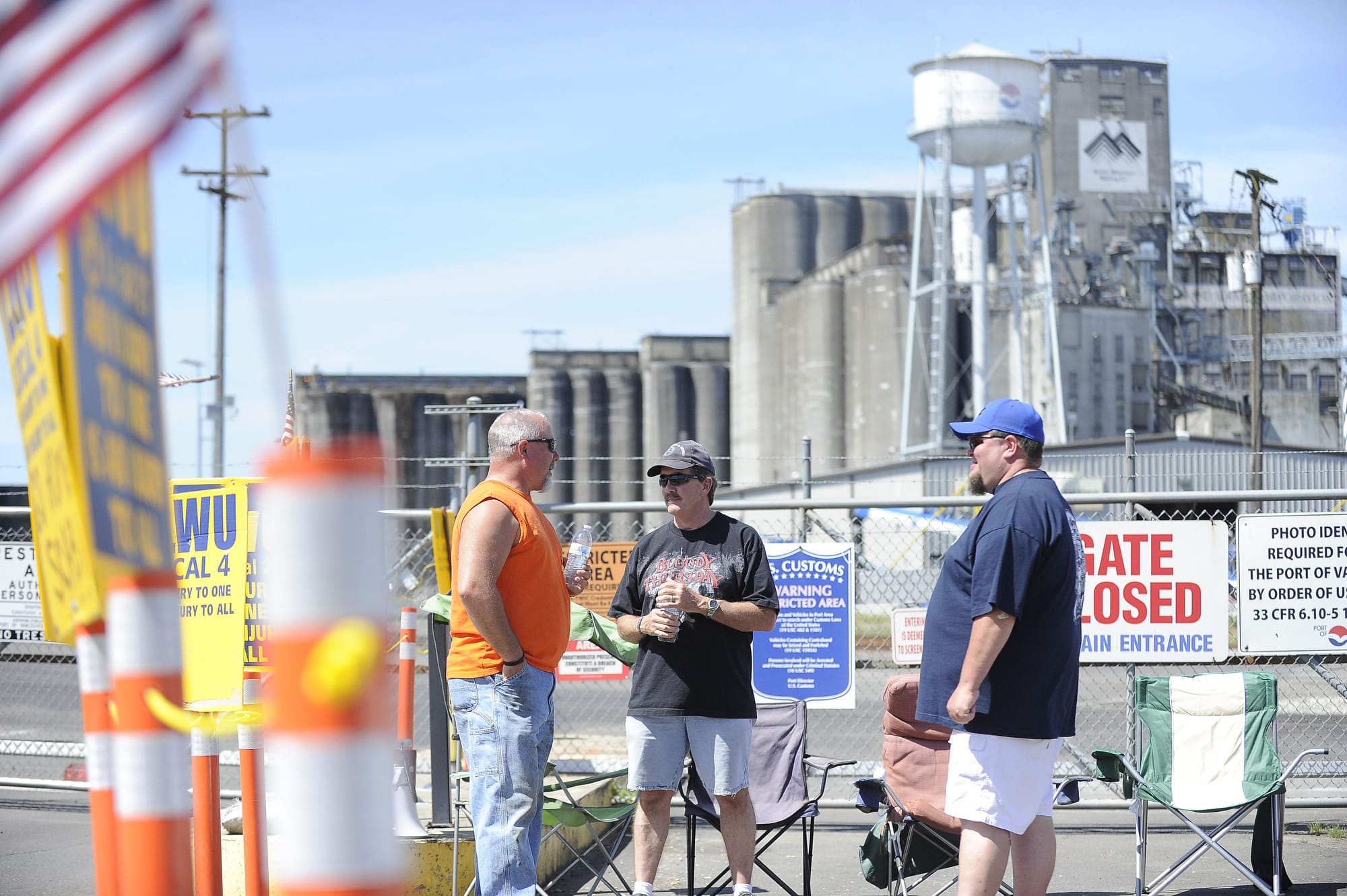 International Longshore and Warehouse Union members John Seidl, from left, Bob Poppe and Shawn Unger picket outside the Port of Vancouver on May 6.