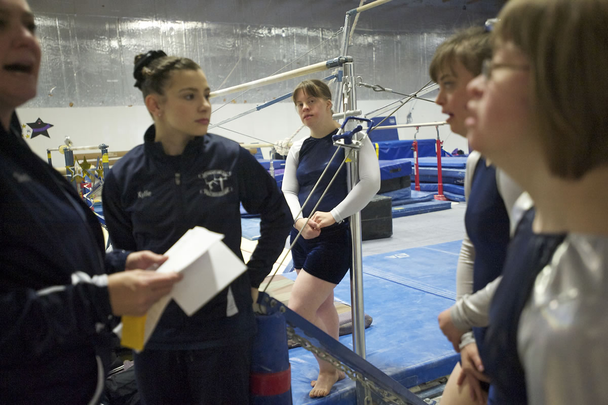 Ccoach Sheri Bousquet, from left, and assistant Kylie Weaver, 14, give instructions to Special Abilities team members Carissa Brown, 33, Geneva &quot;Gigi&quot; Gernhart, 24, and Hadley Park, 27, during Sunday's open meet at Naydenov Gymnastics.