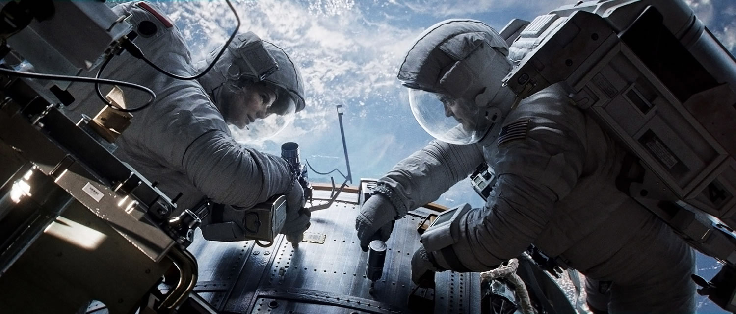 Sandra Bullock, left, and George Clooney play astronauts in peril in &quot;Gravity.&quot;