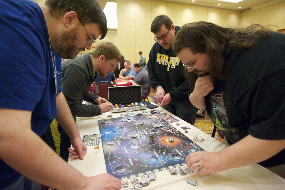 Gamers huddle over an intense match at the Gamestorm board- and card-game convention at the Hilton Vancouver Washington.