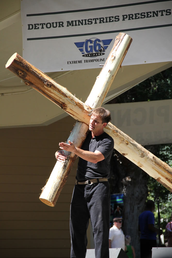 Esther Short: Doug McCary, of Florida's HisLight International Ministries, preaches the lessons of Jesus with a large wooden cross at the annual All Church Picnic on Aug.